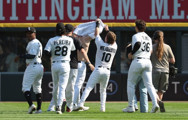 Chicago White Sox center fielder Tristan Peters loses his jersey celebrating with teammates after taking a walk-off walk to defeat the New York Yankees 2-1 in 11 innings Thursday, July 30, 2026, at Rate Field. (Brian Cassella/Chicago Tribune)