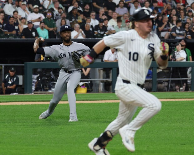 Yankees pitcher Angel Chivilli aims for first base to throw out White Sox second baseman Chase Meidroth (10) on a bunt attempt in the seventh inning at Rate Field on July 28, 2026, in Chicago. (John J. Kim/Chicago Tribune)