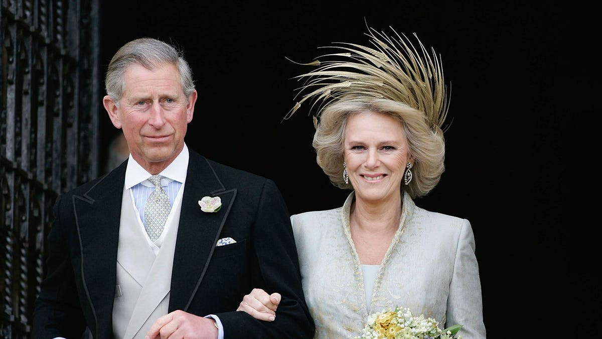 Prince Charles and Camilla stand together at Windsor Castle.