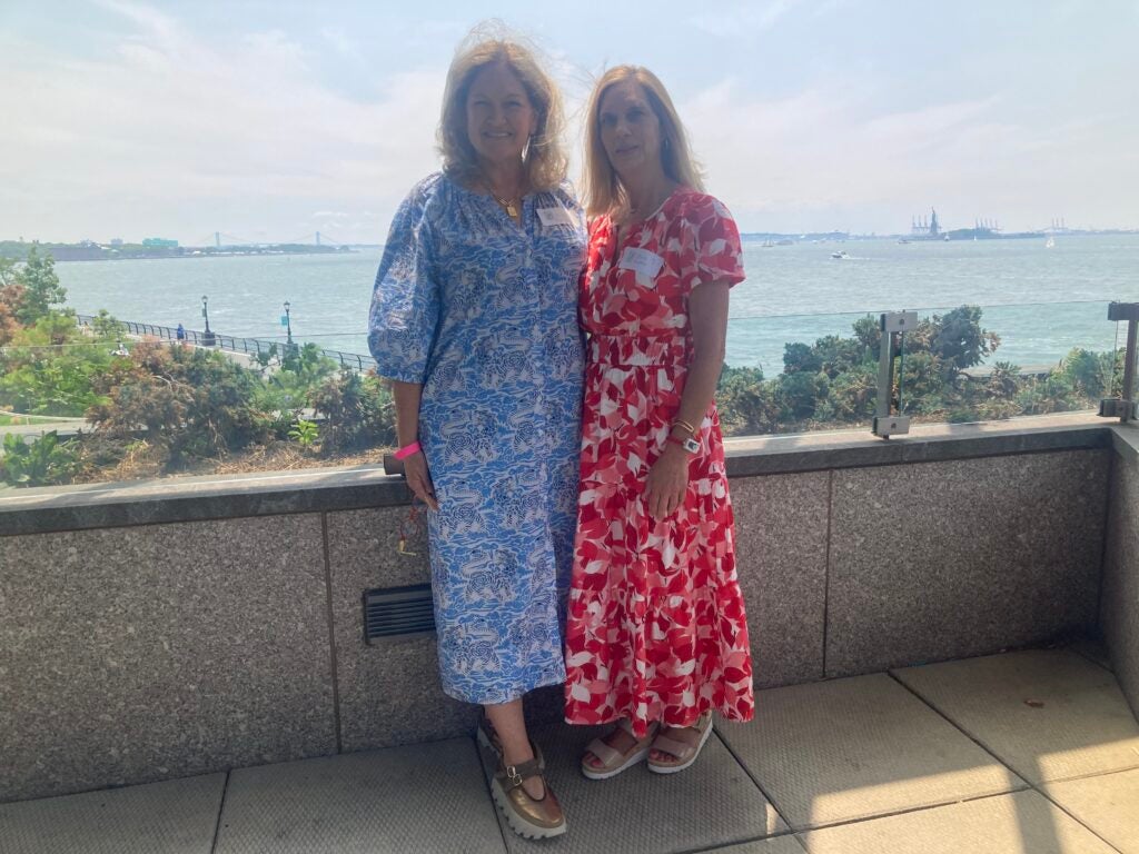 Two women standing in front of a river