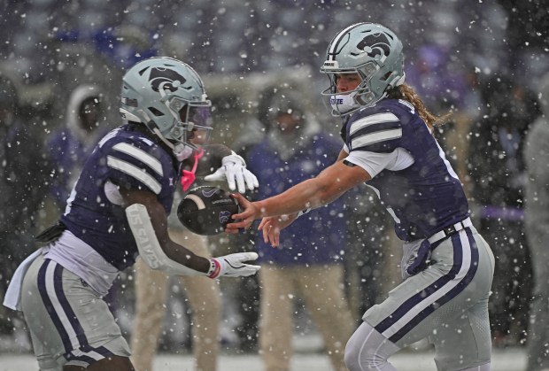 MANHATTAN, KS - NOVEMBER 29: Quarterback Avery Johnson #2 of the Kansas State Wildcats hands the ball off to running back Joe Jackson #4 during pre-game before a game against the Colorado Buffaloes at Bill Snyder Family Football Stadium on November 29, 2025 in Manhattan, Kansas. (Photo by Peter Aiken/Getty Images)