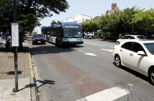A vehicle blocks the faded bus lane along Fordham Rd. in the Bronx on July 11, 2023. (Evan Simko-Bednarski / New York Daily News)