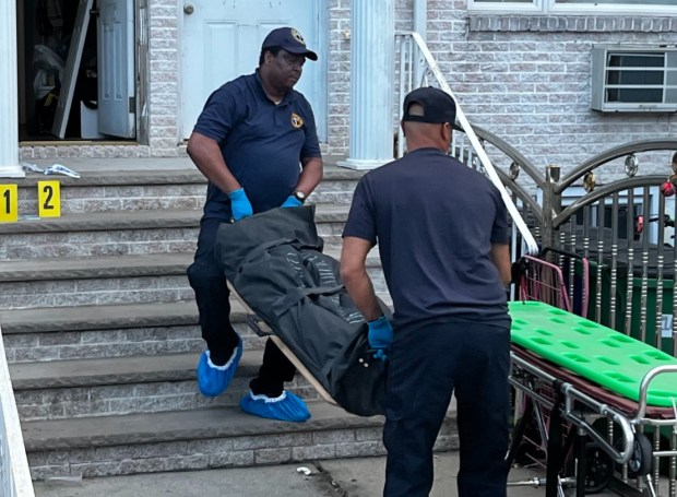 Ausha Ramlakhan's body is removed from her home in South Ozone Park, Queens, after she was stabbed to death on July 4, 2026. (Julian Roberts-Grmela / New York Daily News)
