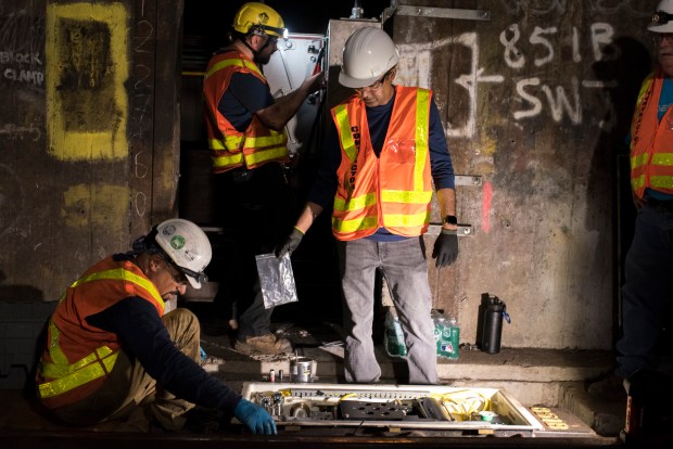 MTA contractors assemble a switch motor at the interlocking south of Court Square subway station. (Evan Simko-Bednarski / New York Daily News)