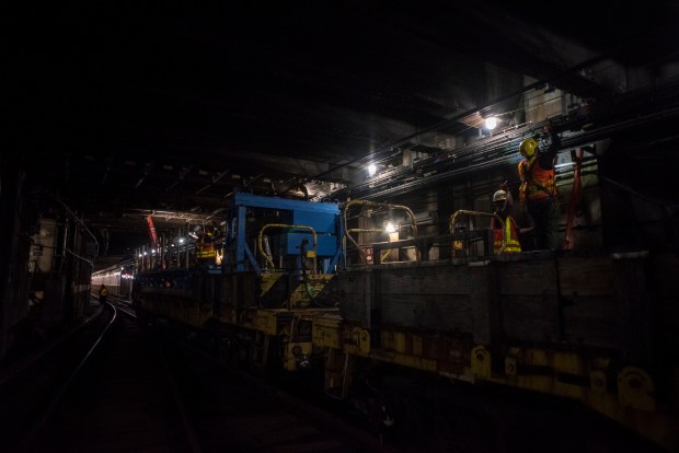 Work crews wrap wires south of Court Square subway station in Long Island City, Queens. (Evan Simko-Bednarski / New York Daily News)