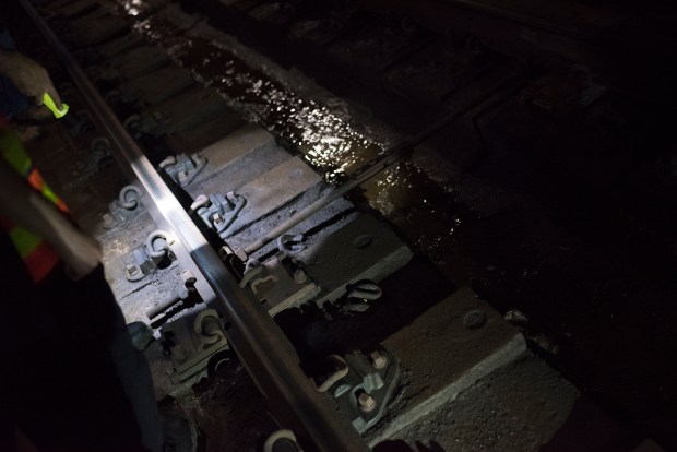 A threaded "gauge rod," installed by MTA track workers, reinforces a stretch of track where water damage has threatened the railroad ties. (Evan Simko-Bednarski / New York Daily News)