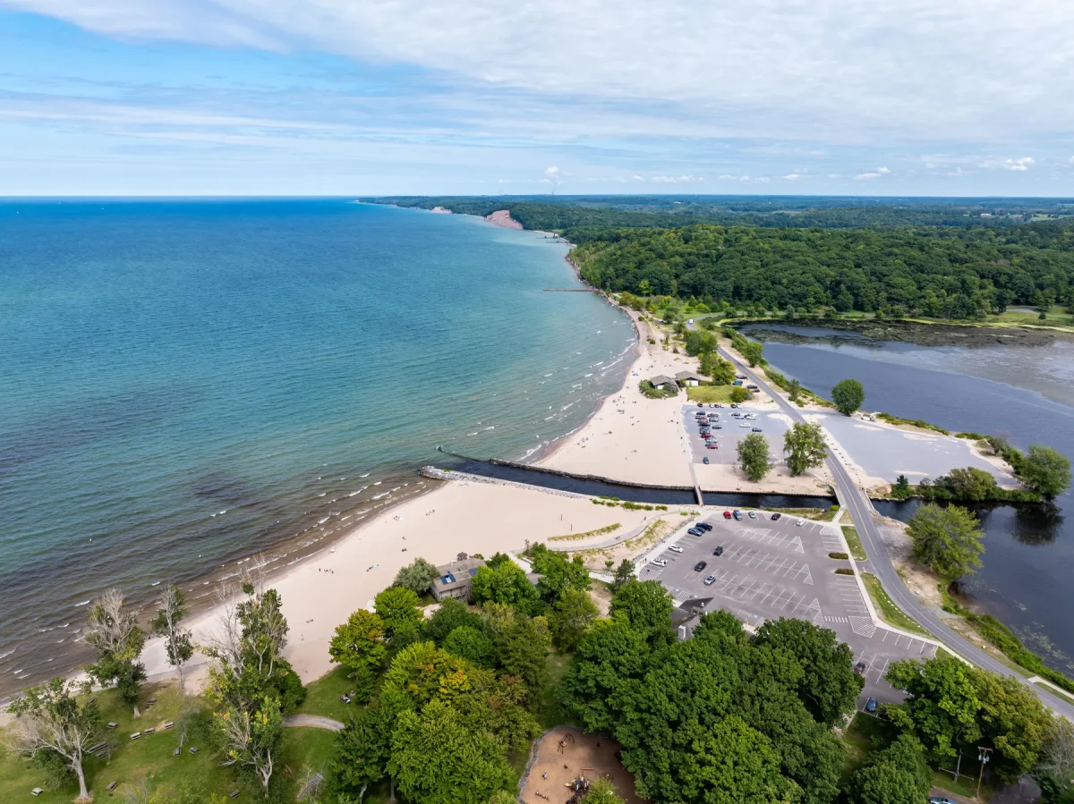 One of New York's largest freshwater beaches is tucked along Lake Ontario—with sandy shores, waterfront camping & unforgettable sunsets