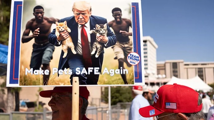 A man carries an AI-generated image of former President Donald Trump carrying cats away from Haitian immigrants