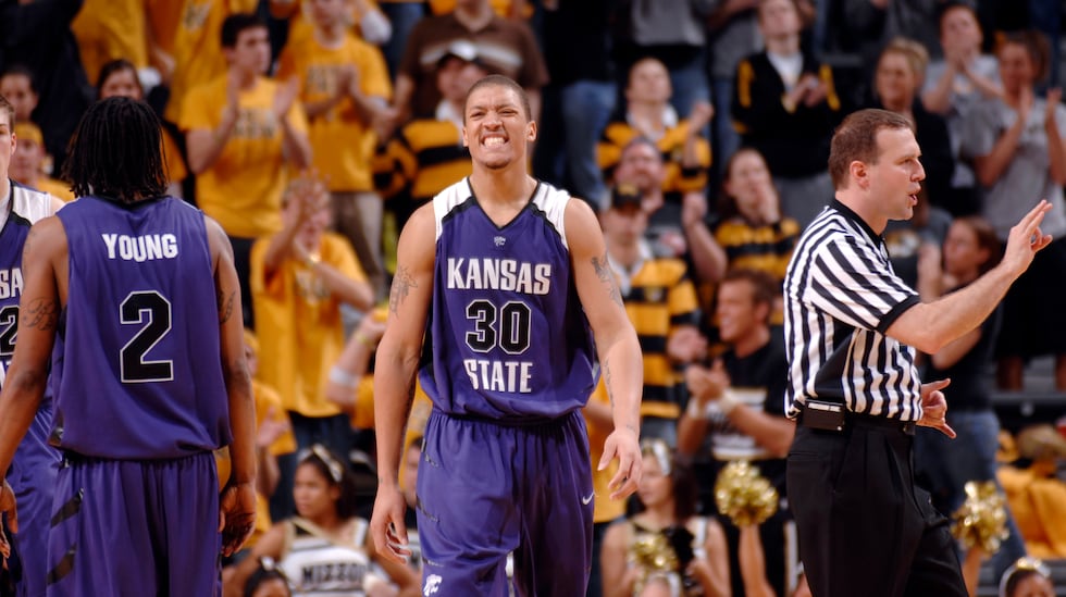 Kansas State's Michael Beasley, center, grimaces after getting his fourth foul during the...