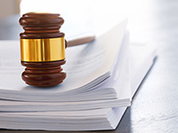 Gavel laying on stacks of papers