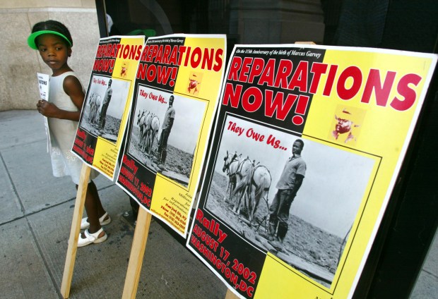 A child attends a slavery reparations protest on Aug. 9, 2002 in New York City. (Photo by Mario Tama/Getty Images).