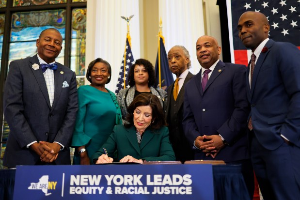 NEW YORK, NEW YORK - DECEMBER 19: New York Gov. Kathy Hochul speaks signs legislation creating a commission for the study of reparations in New York on December 19, 2023 in New York City. Gov. Hochul was joined by Rev. Al Sharpton, various members of New York government leadership and influential community members six months after state lawmakers passed the bill and three years after California became the first state to create a reparations task force. The bill creates a nine-member commission that would study the effects of slavery in the state and make non-binding recommendations on reparations. Three members would be appointed by the governor, three by the assembly and three by the senate. (Photo by Michael M. Santiago/Getty Images)