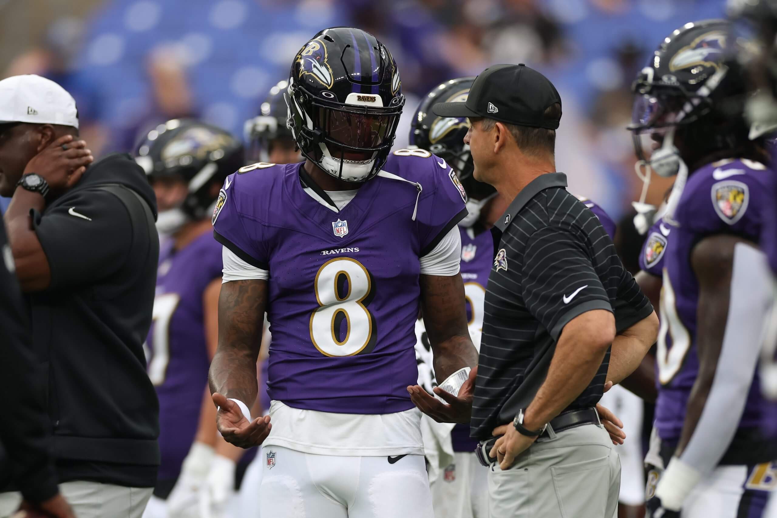 John Harbaugh talks with Lamar Jackson on the sideline before a game against the Indianapolis Colts in 2025.