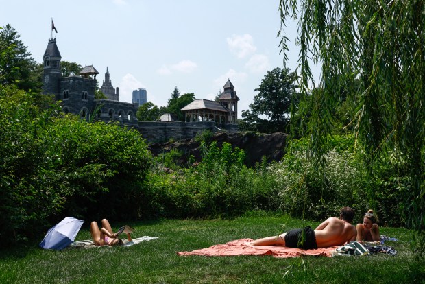 People sunbathe in Central Park during a heatwave in New York City, on July 1, 2026. Tens of millions of Americans sweltered under furnace-like temperatures this week as central and eastern cities hunkered down for a heat wave set to last through the July 4 holiday weekend. Dozens of local temperature records could be broken, the National Weather Service (NWS) warned, with temperatures in many places to surpass 100 degrees Fahrenheit (38 degrees Celsius) and high humidity pushing the heat index as high as 115 degrees. (Photo by kena betancur / AFP via Getty Images)