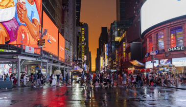 People cross 7th Avenue during a colorful sunset in Times Square after a rain shower on July 03, 2026 in New York, New York. The heat wave, stretching from the midwest to east coast, will affect as many as 90 million Americans.