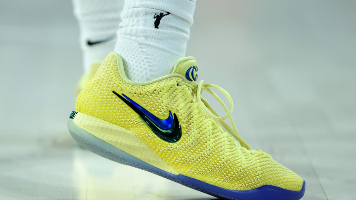 Caitlin Clark wears yellow Nike shoes during a game in Las Vegas.
