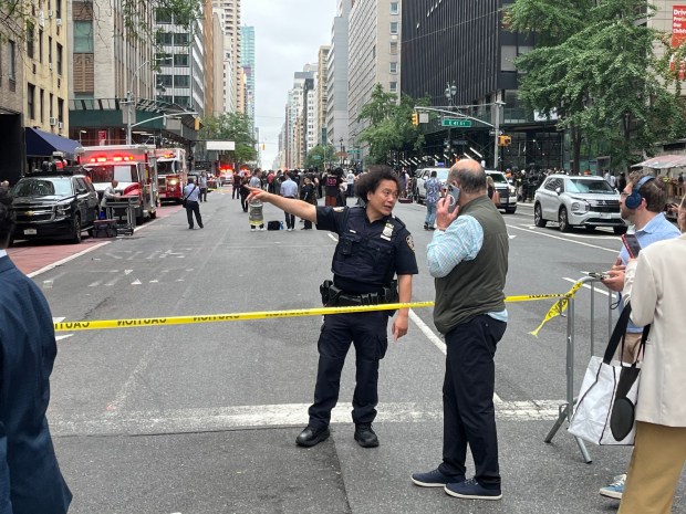 A police officer directs a pedestrian after 2nd Ave. was closed to traffic on Tuesday. (Lincoln Anderson / New York Daily News)