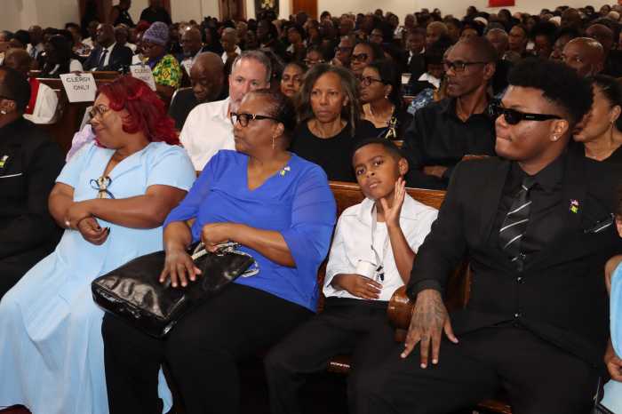 Rev. Beach's widow, Candace Beach, second from left, in front pew, with Rev. Beach's eldest daughter, Leticia, left, front pew, and other family members. 