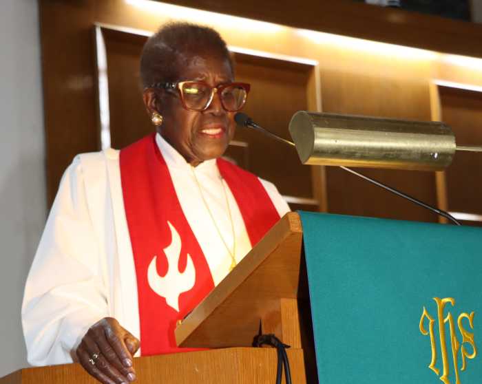 The Rev. Dr. Gennifer Brooks reads the obituary.