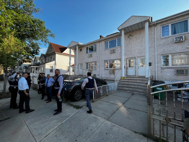 Police at the scene in South Ozone Park, Queens, where a 60-year-old woman was slashed to death in her home on July 4, 2026. 