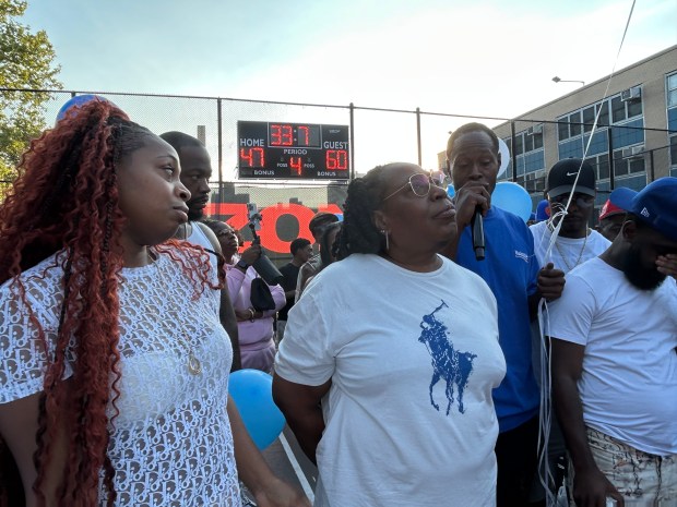 Eden Rochford (center), the mother of Kinu Rochford, with his sister, Kye (left) and his brother, Kairo (right), during a memorial for the former basketball player, who was shot and killed in Harlem. (Kerry Burke / New York Daily News)