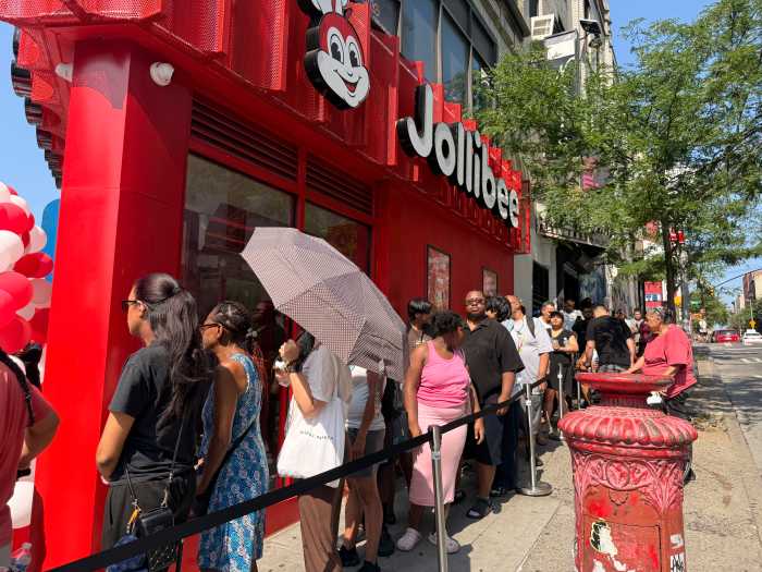 Lines of people wait to become the first customers of the first Jollibee in the Bronx.