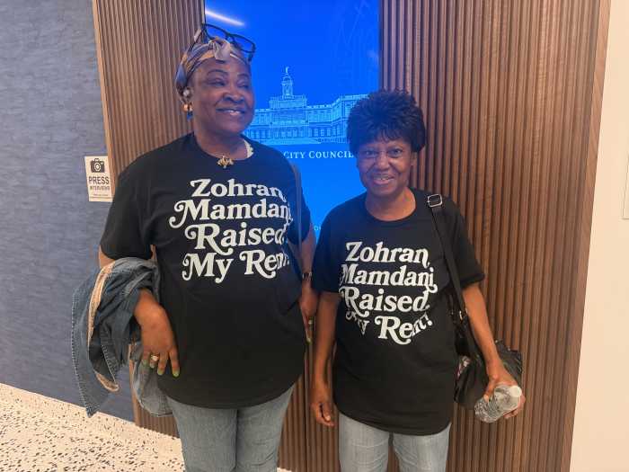 Tracey Towers residents Haija Lami Yusuf and Susanna Armah wear shirts reading "Zohran Mamdani raised my rent!" to protest the proposed rent hike.
