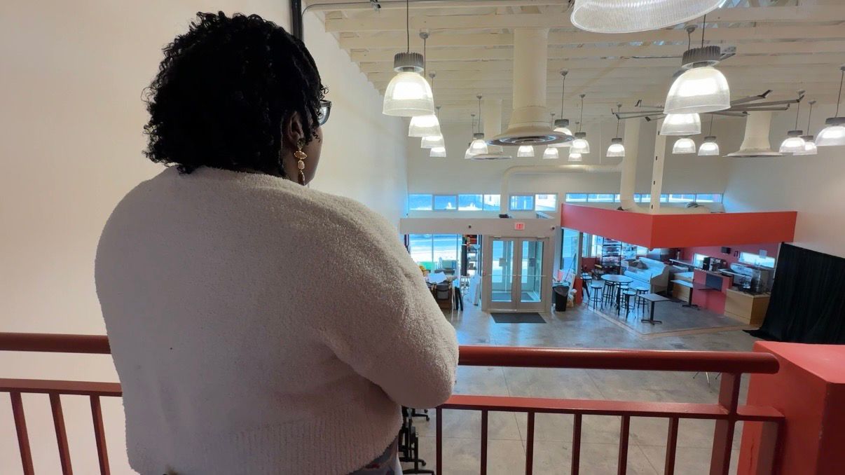 Executive Director Sequoia Kemp looks out over the cafe. (Spectrum News/Natalie Mooney)