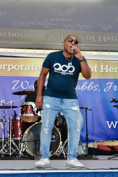 Lead male vocalist of the Caribbean Angels Band Dexter M on stage in Denton Green Park, at the 5th Annual Summer concert on July 17.