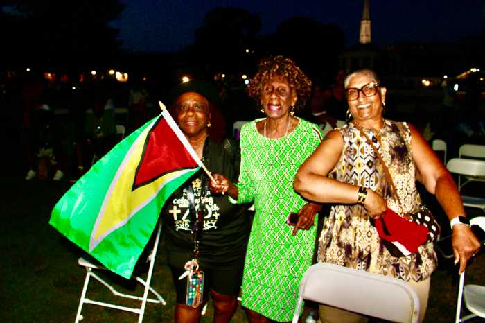 A group of ladies dance to the infectious Caribbean music while waving their flags at the Caribbean Angels Band 5th Annual summer concert on July 17.