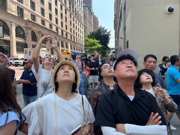 People look up at the Empire State Building Wednesday after two people climbed its top spire. (Barry Williams / New York Daily News)