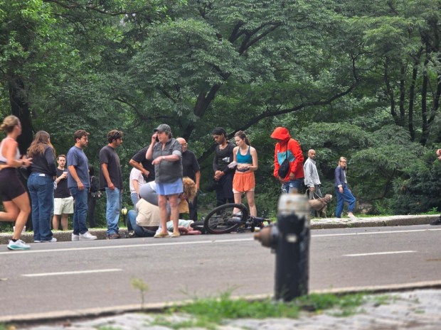The crash scene on Central Park's West Drive at W. 64th St. on July 7, showing Jean, the jogger, and the cyclist's e-bike that hit her both lying on the ground in the pedestrian lane that's used by joggers. (Courtesy of Hoon Chan Sim)