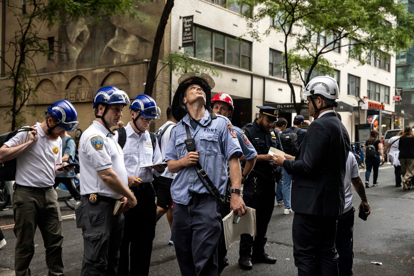 Emergency workers gathered in midtown Manhattan after several buildings were evacuated due to the potential collapse of one of them on Tuesday.