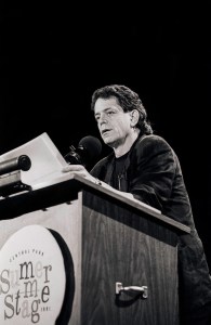 American rock musician and songwriter Lou Reed (born Lewis Allan Reed, 1942-2013) reads from his works at Central Park SummerStage, New York, New York, Thursday, July 11, 1991.