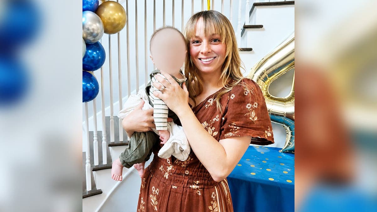 image shows Golding holding a baby