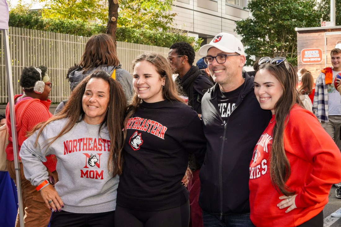 Northeastern students pose for a photo with their parents.