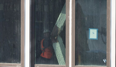 A construction worker looks at a buckled support beam inside 235 East 42nd Street.