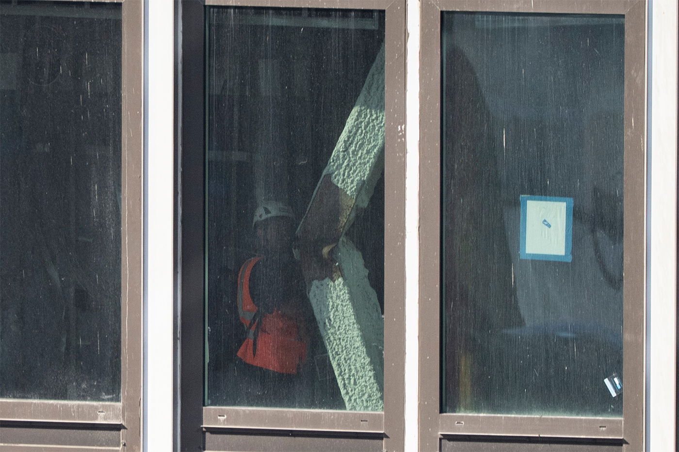 A construction worker looks at a buckled support beam inside 235 East 42nd Street.