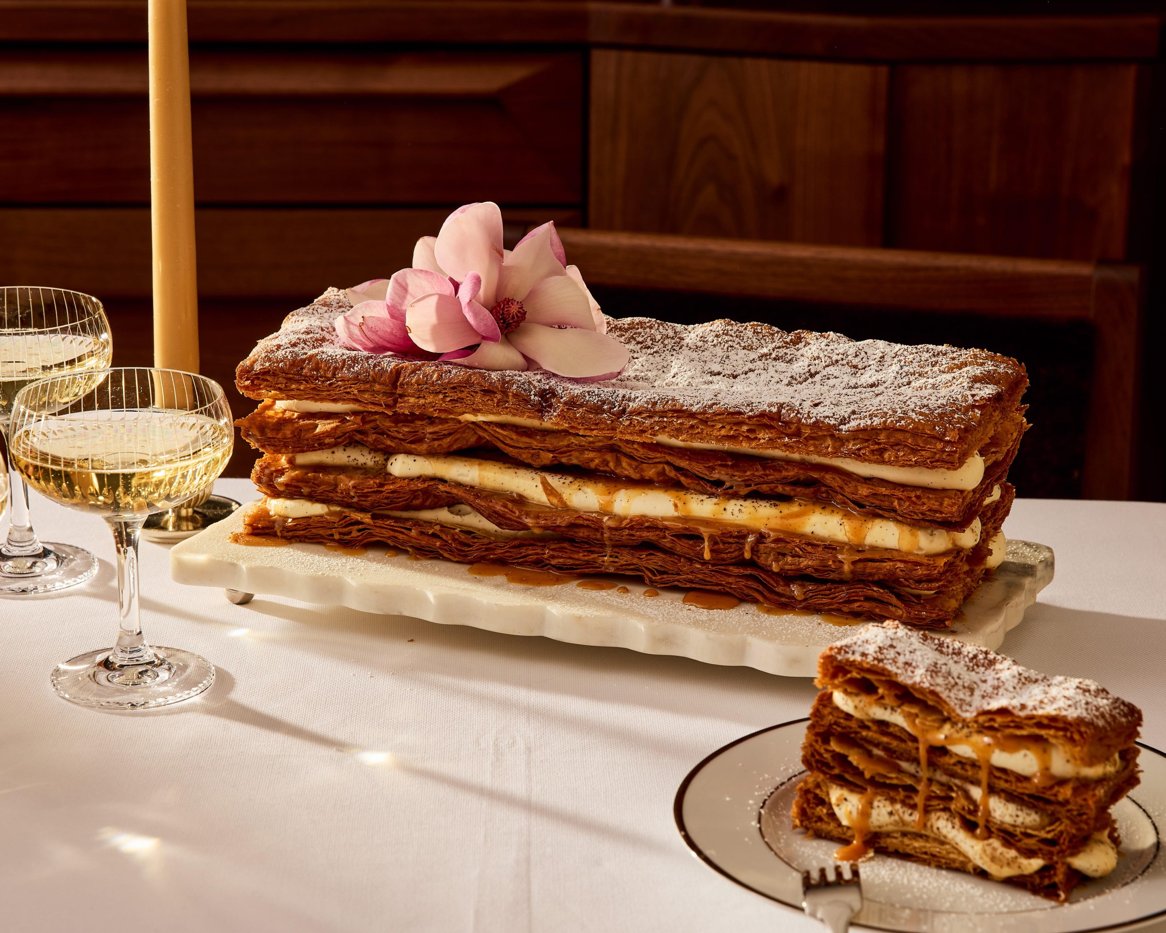 A huge layered dessert with crispy layers and cream.