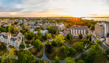 aerial panoramic view of Queen's campus with a golden hour sunset