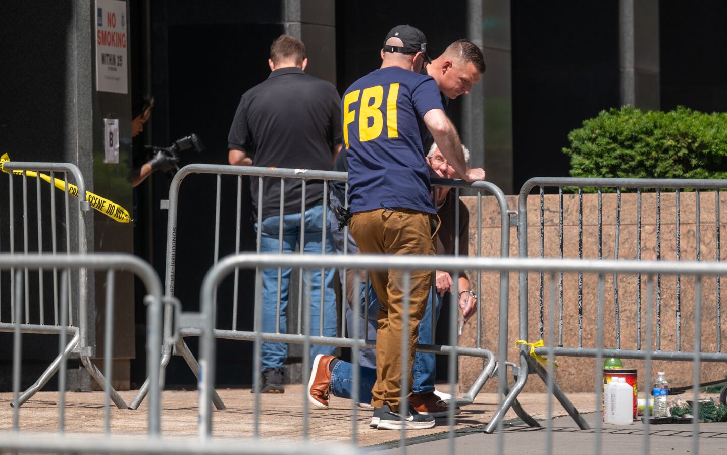 Investigators from various agencies, including the FBI, gather outside of 26 Federal Plaza in Lower Manhattan after an incendiary device went off outside the building early on July 20, 2026 in New York City.
