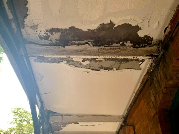 An exterior ceiling leaks when it rains, and gets more damaged over time. Photo: Mary Frost/Brooklyn Eagle
