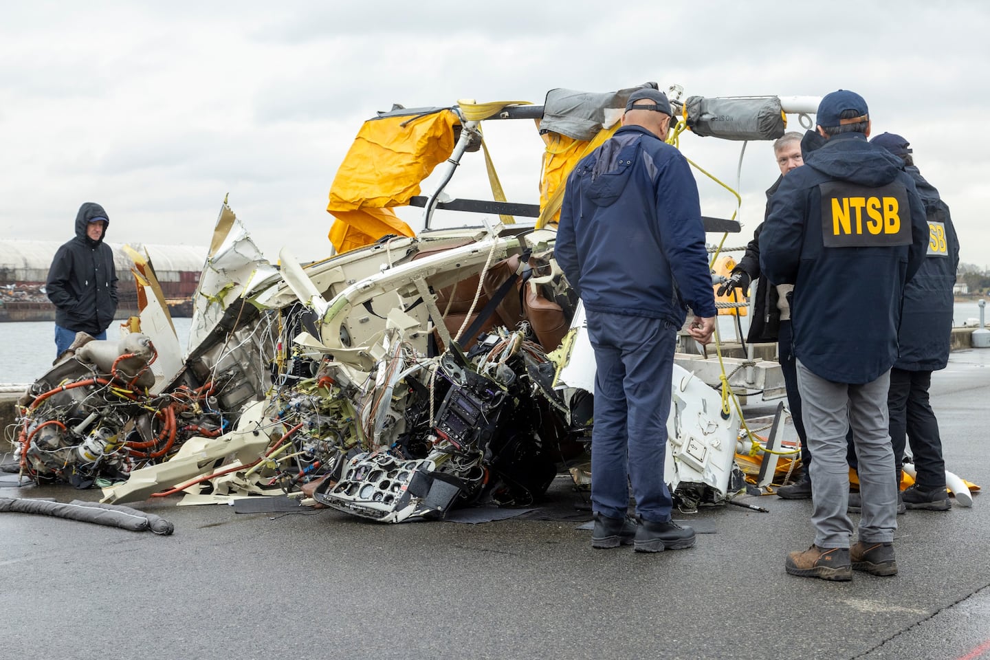 National Transportation Safety Board investigators examined the remains of the helicopter retrieved from the Hudson River following the crash.
