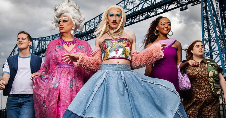 Smoggie Queens still, five individuals walking against a grey cloudy sky