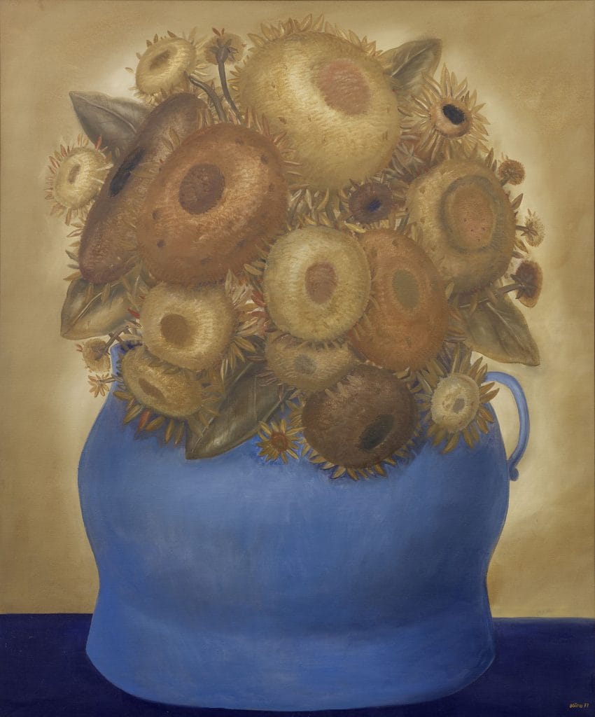 Sunflowers presents a lush bouquet of oversized blooms overflowing from a rounded blue vase against neutral background.