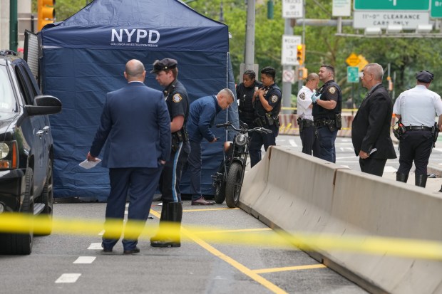 NYPD officers and detectives investigate a fatal e-bike collision on Centre St. near Chambers St. in Lower Manhattan on Wednesday, July 29, 2026 in New York City. (Barry Williams/ New York Daily News)