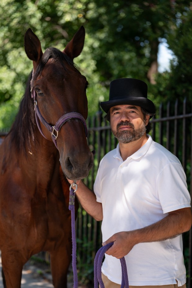 Horse carriage owner and driver Ahmet Bilici poses with his horse Chocolate at the Clinton Park Stables Association stables on W. 52nd St. Thursday, July 23 2026 in New York. (Barry Williams/ New York Daily News)