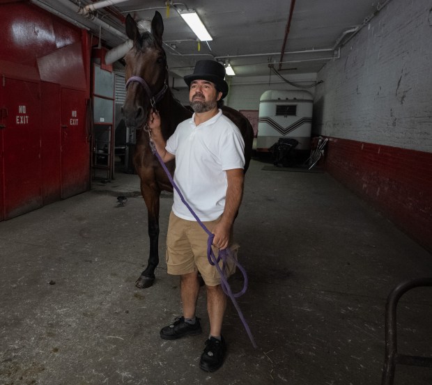 Horse carriage owner and driver Ahmet Bilici waits for Dr. Cook to conduct Chocolate's twice yearly health exam at the Clinton Park Stables Association stables on W. 52nd St. Thursday, July 23 2026 in New York. (Barry Williams/ New York Daily News)