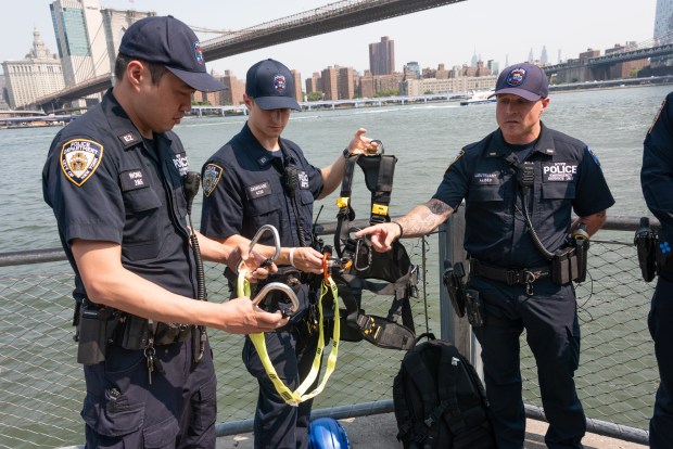 Lt. Michael Aliseo of the NYPD Emergency Service Unit, right, shows some of the equipment his colleagues used during last week's dramatic rescue on the Brooklyn Bridge on July 14, 2026 in New York. (Gardiner Anderson / New York Daily News)