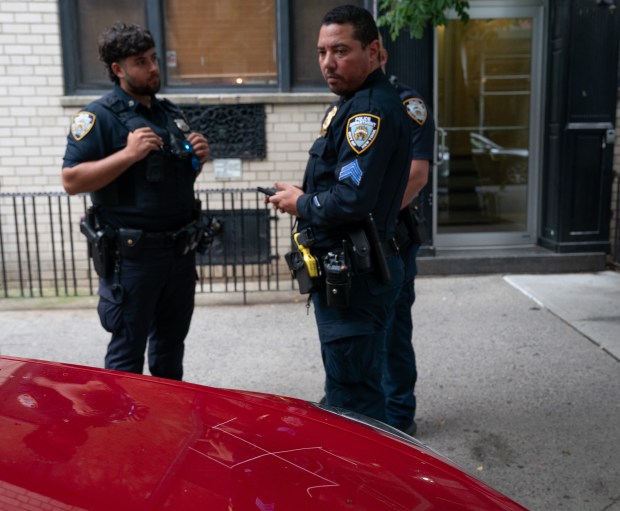 NYPD officers from the 19th Pct. investigate a vehicle that had a swastika carved in its hood on E. 85th St. blocks from Gracie Mansion Friday, June 26, 2026 in the Manhattan, New York. (Barry Williams/ New York Daily News)